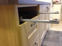 Drawer box runners extended from kitchen unit