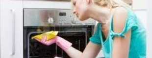 Woman cleaning an oven with baking soda
